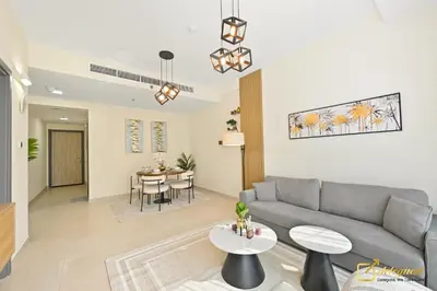 a living room with a couch and a table at 1BR Modern Escape in JVC Dubai in Dubai