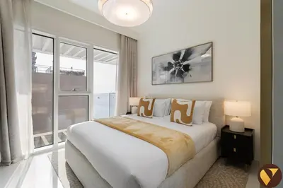 a bedroom with a large bed and a large window at Vogue Emaar Beachfront Grand Bleu Designed by Elie Saab, near JBR and Palm Jumeirah, Two Bedroom Apartment with Balcony and Private Beach, Access to all Amenities in Dubai