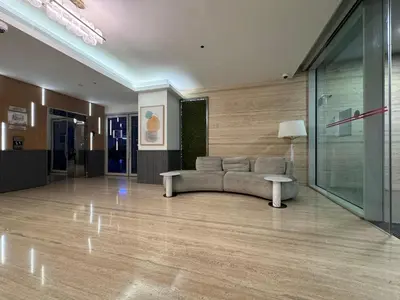 a living room with a couch in the middle of a room at Mahenti - Serene & Comfortable Apartment in Dubai