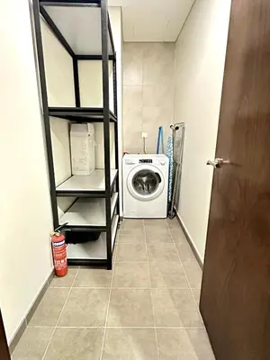 a laundry room with a washer and dryer at Luxury 2BR with Dubai Canal View Near Burj Khalifa in Dubai