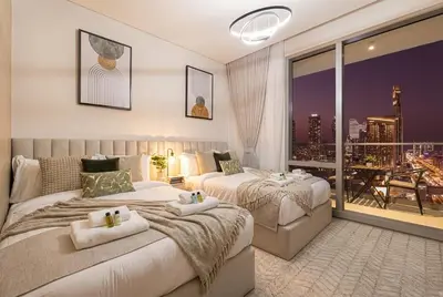 a bedroom with two beds and a balcony at Vida Dubai Mall! 2 Bedroom with Burj Khalifa View! Direct Access to Dubai Mall in Dubai