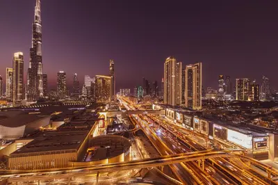 a city skyline at night with traffic at Vida Dubai Mall! 2 Bedroom with Burj Khalifa View! Direct Access to Dubai Mall in Dubai
