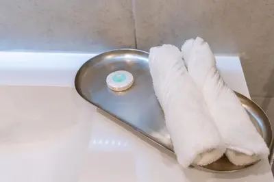a plate with a towel and a donut on it at 1BR Apartment next to Dubai Mall & Burj Khalifa in Dubai