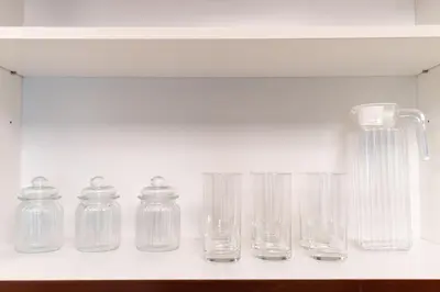a row of glass jars sitting on a shelf at 1BR Apartment next to Dubai Mall & Burj Khalifa in Dubai