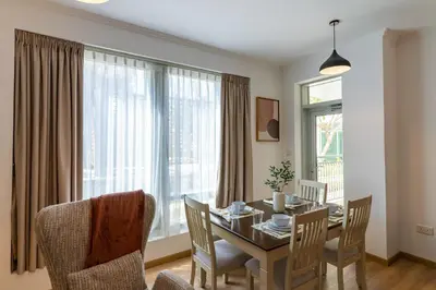 a dining room with a table and chairs and a window at 1BR Apartment next to Dubai Mall & Burj Khalifa in Dubai