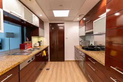 a large kitchen with wooden counter tops and wooden cabinets at 1BR Apartment next to Dubai Mall & Burj Khalifa in Dubai