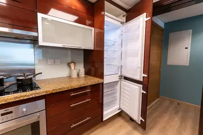 a kitchen with white cabinets and a stove at 1BR Apartment next to Dubai Mall & Burj Khalifa in Dubai