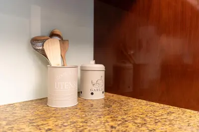 two canisters sitting on a counter with wooden spoons at 1BR Apartment next to Dubai Mall & Burj Khalifa in Dubai