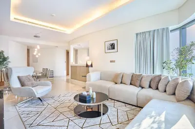 a living room with a couch and a table at Burj Khalifa View High-Floor Upgraded 3Bed Apt in Dubai