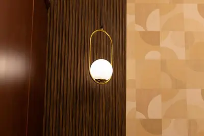 a light hanging on a wall in a room at Lux 3 Bedroom apartment in Marina DEC 1103 in Dubai