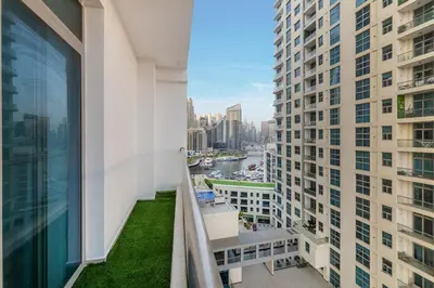 a balcony with a view of a river and buildings at Lux 3 Bedroom apartment in Marina DEC 1103 in Dubai