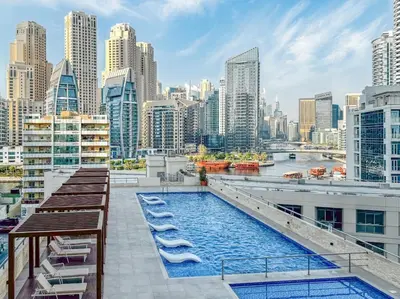 a pool on the roof of a building with a city at Lux 3 Bedroom apartment in Marina DEC 1103 in Dubai