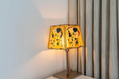 a yellow lamp sitting on a table next to a curtain at Boulevard Point I Burj Khalifa Fireworks View in Dubai