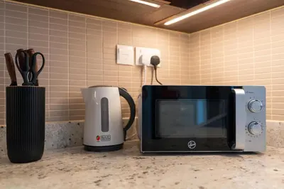 a microwave and a coffee maker on a counter at Boulevard Point I Burj Khalifa Fireworks View in Dubai
