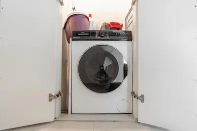 a washing machine in a room with two open doors at King 2 Bedroom With Burj Khalifa View & Dubai Mall Access in Dubai