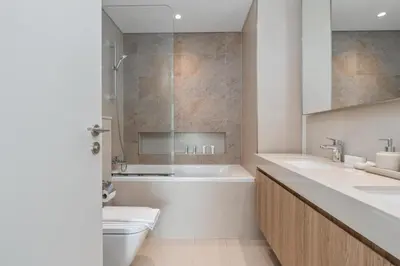 a bathroom with a tub and a toilet and a sink at King 2 Bedroom With Burj Khalifa View & Dubai Mall Access in Dubai