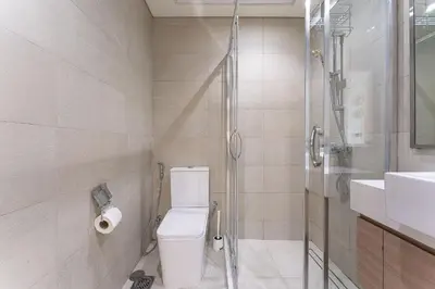 a bathroom with a shower and a toilet and a sink at HAVN - Spacious 1 bedroom in Azizi Riviera, Meydan in Dubai