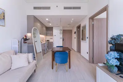 a living room with a couch and a table at HAVN - Spacious 1 bedroom in Azizi Riviera, Meydan in Dubai