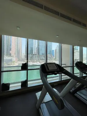 a gym in a building with a view of the city at Two Bedroom apartment - Dubai Marina in Dubai