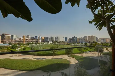 a view of a park with a city in the background at Casa Haven Retreat in Dubai