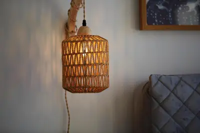 a wicker lamp hanging from a wall at Casa Haven Retreat in Dubai