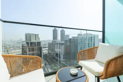 a balcony with a view of a city at StayShort - Stylish Boho Studio in JVC Dubai Staycation Sleeps 2 in Dubai