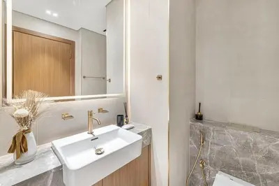 a bathroom with a white sink and a mirror at Studio Apartments with Private Jacuzzi - Spa - Cold Plunge - Gym in Business Bay in Dubai