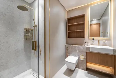 a bathroom with a toilet and a sink and a shower at Studio Apartments with Private Jacuzzi - Spa - Cold Plunge - Gym in Business Bay in Dubai