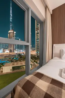 a bedroom with a large window with a view of the city at Luxury 4BR Burj Khalifa View Dubai Mall in Dubai