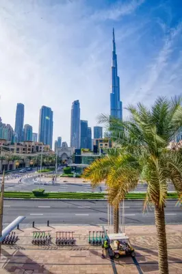 a view of the dubai city skyline with two palm trees at Luxury 2BR in Dubai Downtown Steps to Burj Khalifa and Dubai Mall with Burj Khalifa View by La Brisa in Dubai