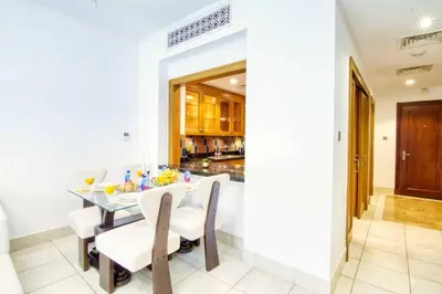 a dining room with a table and chairs at Luxury 2BR in Dubai Downtown Steps to Burj Khalifa and Dubai Mall with Burj Khalifa View by La Brisa in Dubai