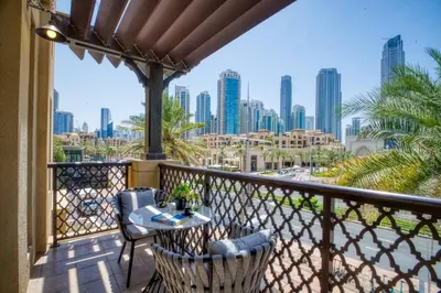 a balcony with a table and chairs and a view of the city at Luxury 2BR in Dubai Downtown Steps to Burj Khalifa and Dubai Mall with Burj Khalifa View by La Brisa in Dubai