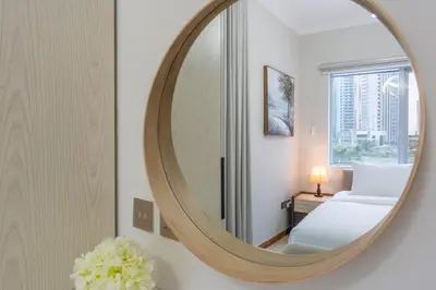 a mirror in a hotel room with a bed at Prestigious 2BR with nice View of Marina Dubai in Dubai