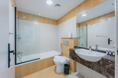 a bathroom with a sink and a tub and a toilet at Prestigious 2BR with nice View of Marina Dubai in Dubai