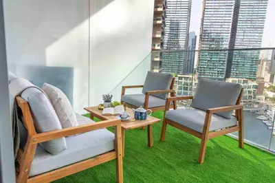 two chairs and a table on a balcony at Frank Porter - Liv Marina in Dubai