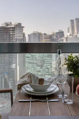 a table with a plate of food and a window at Frank Porter - Boulevard Walk Downtown in Dubai