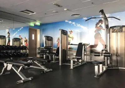a gym with a mural of a woman running at Frank Porter - Boulevard Walk Downtown in Dubai