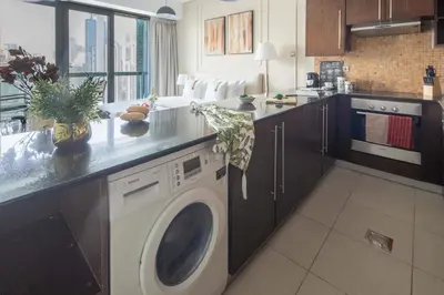 a kitchen with a washing machine in a kitchen at Frank Porter - Boulevard Walk Downtown in Dubai