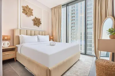 a bedroom with a large white bed and a large window at STAY BY LATINEM Luxury 1BR Plus Study Holiday Home CC 3109 Near Burj Khalifa in Dubai