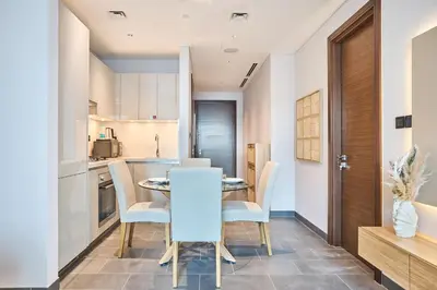 a kitchen and dining room with a table and chairs at STAY BY LATINEM Luxury 1BR Plus Study Holiday Home CC 3109 Near Burj Khalifa in Dubai