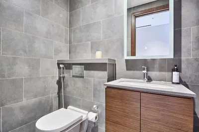 a bathroom with a toilet and a sink at STAY BY LATINEM Luxury 1BR Plus Study Holiday Home CC 3109 Near Burj Khalifa in Dubai