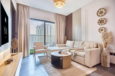 a living room with a couch and a table at STAY BY LATINEM Luxury 1BR Plus Study Holiday Home CC 3109 Near Burj Khalifa in Dubai