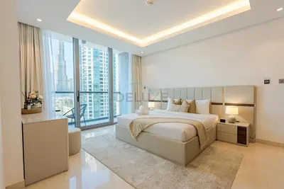 a bedroom with a large bed and a large window at Burj Khalifa Views, Walking Distance to Dubai Mall and Downtown Boulevard - The Sterling West House, Business Bay by Deluxe Holiday Homes in Dubai