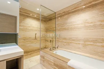 a bathroom with a tub and a glass shower at Burj Khalifa Views, Walking Distance to Dubai Mall and Downtown Boulevard - The Sterling West House, Business Bay by Deluxe Holiday Homes in Dubai