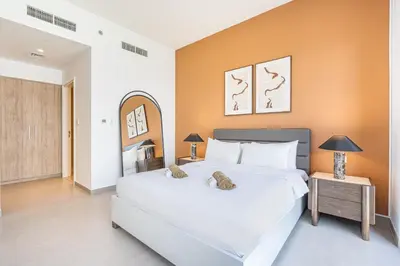 a bedroom with a large white bed in a room at Luxury Modern Home with Direct Park Access in Dubai