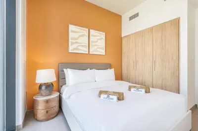two beds in a room with orange walls at Luxury Modern Home with Direct Park Access in Dubai