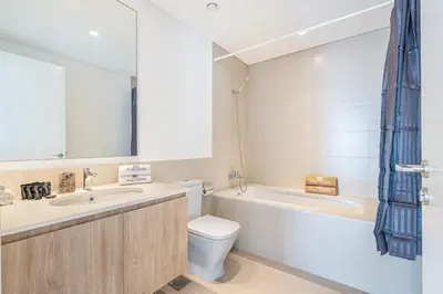 a bathroom with a sink and a toilet and a bath tub at Luxury Modern Home with Direct Park Access in Dubai