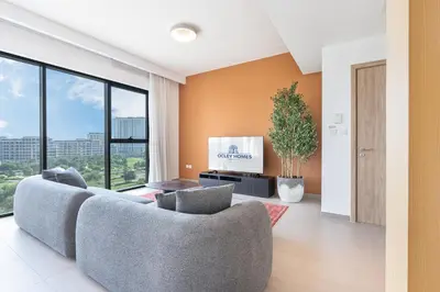 a living room with a couch and a tv at Luxury Modern Home with Direct Park Access in Dubai