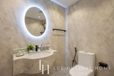 a bathroom with a sink and a mirror at LUX The Marina View Suite 3 in Dubai