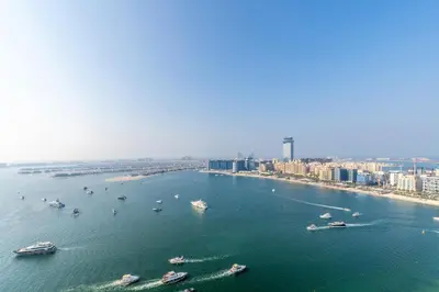 a group of boats in the water near a city at Luxurious Bliss - 3-BR plus maids - Grand Bleu by Elie Saab in Dubai